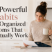 Organized mom in a modern kitchen holding a coffee mug while reviewing a paper beside the title “5 Powerful Habits of Organized Moms That Actually Work”.