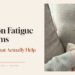 Overwhelmed mother holding her baby at night while managing household planning and mental load, representing decision fatigue for moms.