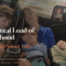 Exhausted mother sitting at a table with a mental checklist, illustrating the invisible mental load of motherhood